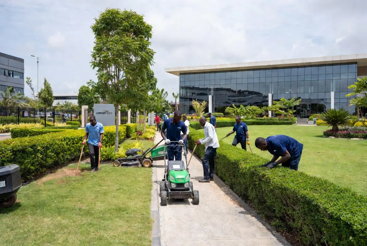 Carpet-grass lawn and landscaped frontage kept tidy at a corporate premises in Airport City, Accra